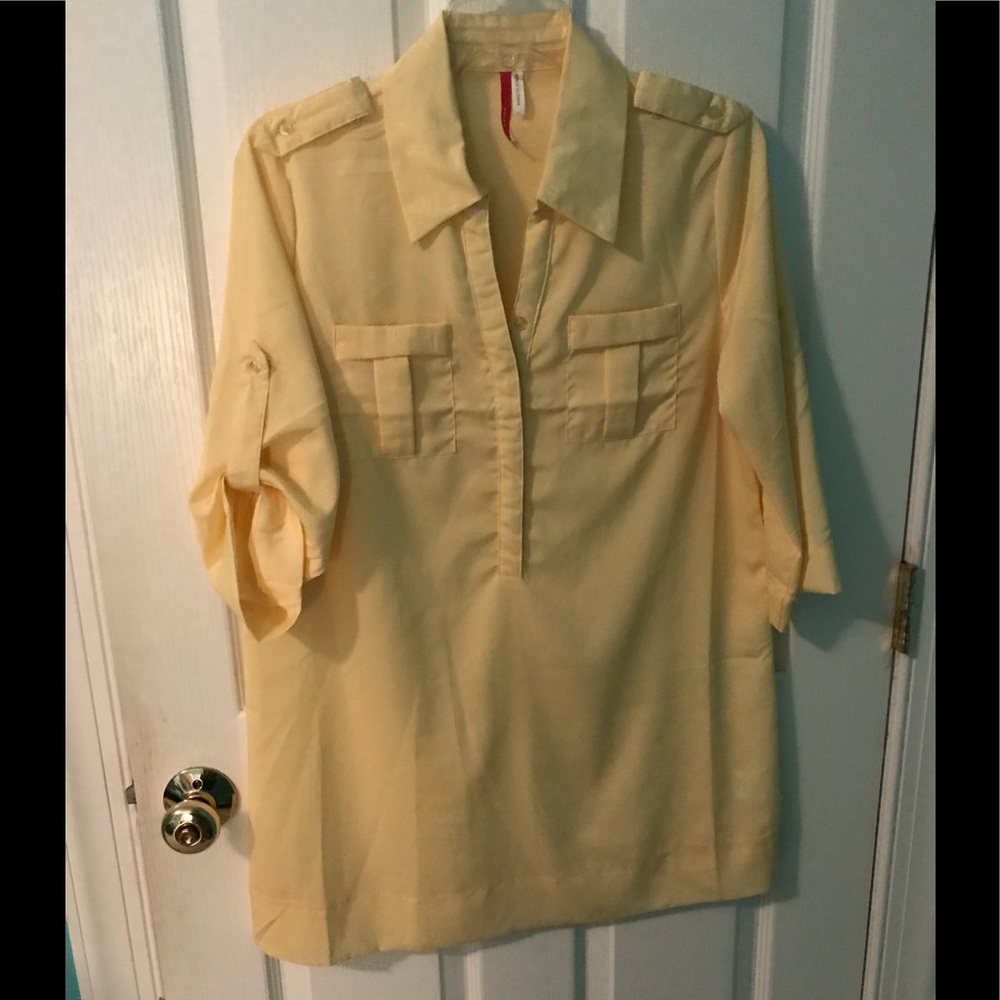 Pale yellow button up shirt.